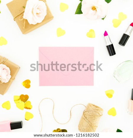 Composition with roses, pink envelope, cosmetics and gifts on white background. Flat lay, top view. Valentines day concept