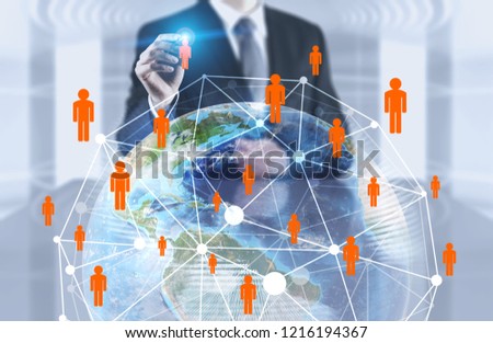 Unrecognizable businessman in office using Earth hologram and global people network. Toned image double exposure mock up. Elements of this image furnished by NASA