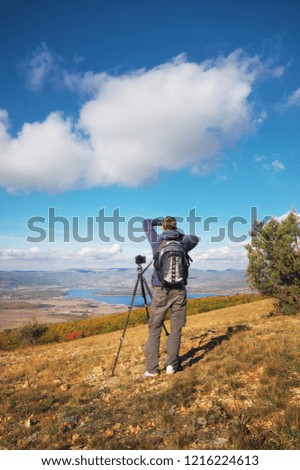 Traveler in the mountains. Photographer on top of mountain. 