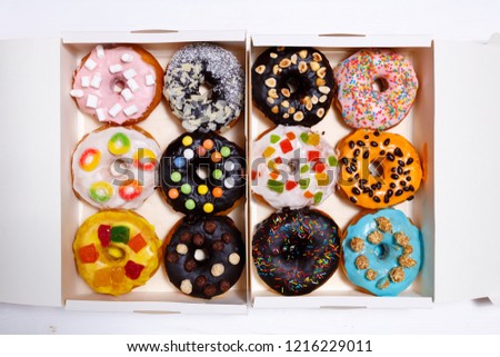 Multicolored donuts isolated on white background. Top view