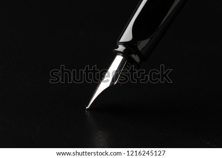 Fountain pen with clipping path on black background Royalty-Free Stock Photo #1216245127