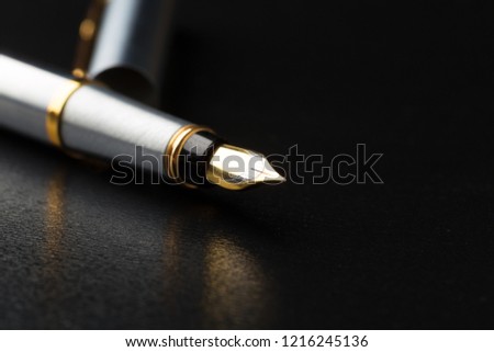 Fountain pen with clipping path on black background Royalty-Free Stock Photo #1216245136