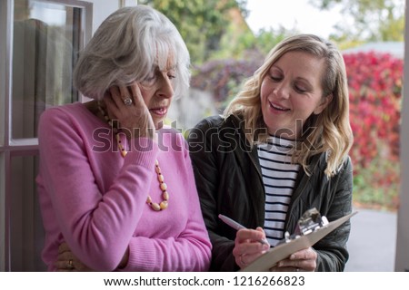 Female Sales Person Trying To Persuade Senior Woman To Purchase Goods Or Services