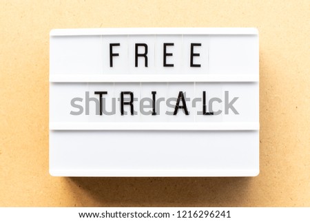 Light box with word free trial on wood background