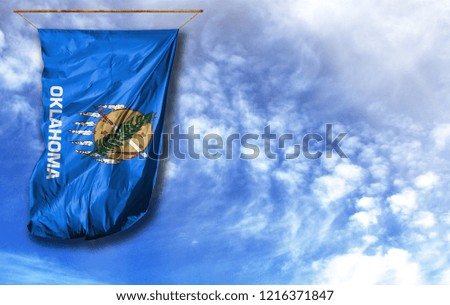 Flag State of Oklahoma. Vertical flag, against blue sky with place for your text