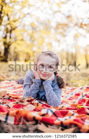 Beautiful little girl in autumn park
