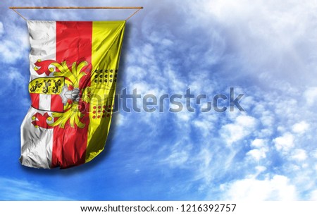 Flag of Carinthia. Vertical flag, against blue sky with place for your text