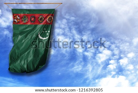 Flag of Turkmenistan. Vertical flag, against blue sky with place for your text