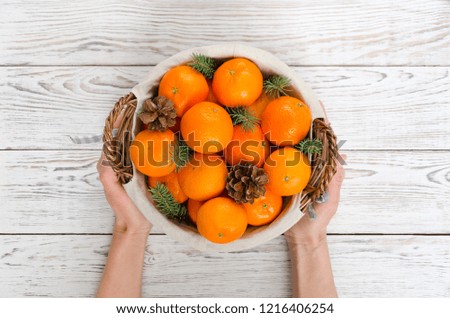 Basket with Tangerines Fir Tree Cones. Christmas New Year Card. Holiday Background. Overhead shots