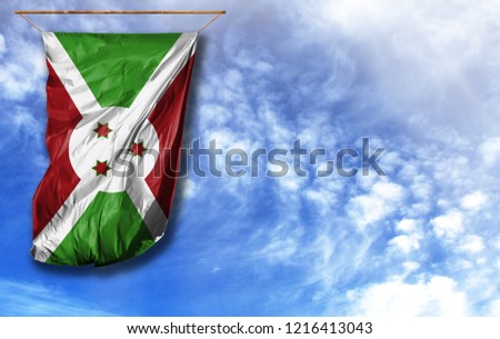 Flag of Burundi. Vertical flag, against blue sky with place for your text