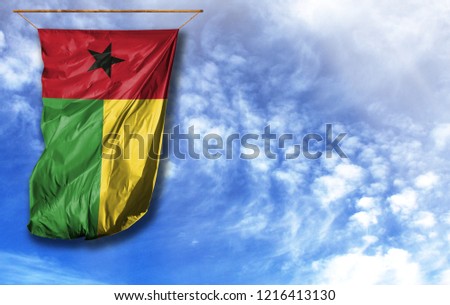 Flag of Guinea Bissau. Vertical flag, against blue sky with place for your text