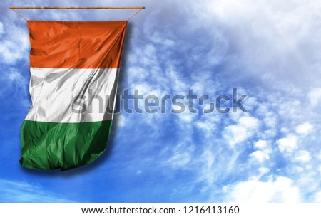 Flag of Cote d,lvoire. Vertical flag, against blue sky with place for your text