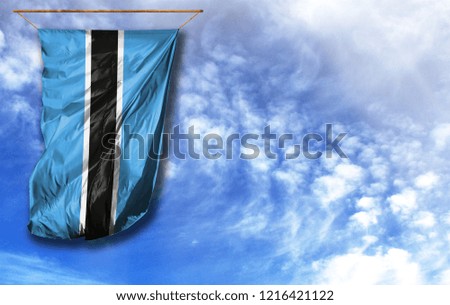 Flag of Botswana. Vertical flag, against blue sky with place for your text