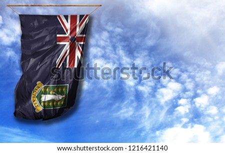 Flag of British Virgin Islands. Vertical flag, against blue sky with place for your text