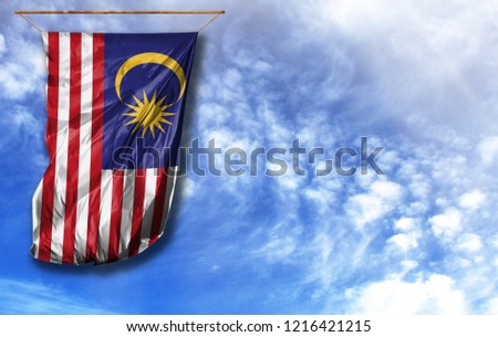 Flag of Malasia. Vertical flag, against blue sky with place for your text