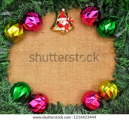 Christmas and New Year background decoration. Frame made of blank concept, pine branches, toys on sack background. Flat lay, top view.