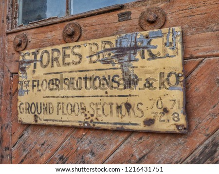 An old sign on a weathered door
