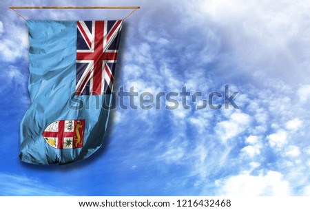 Flag of Fiji. Vertical flag, against blue sky with place for your text