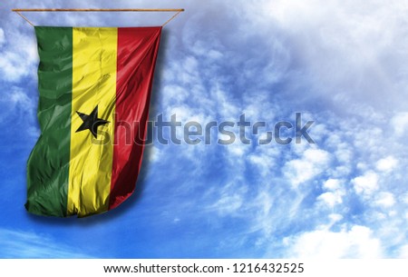 Flag of Ghana. Vertical flag, against blue sky with place for your text