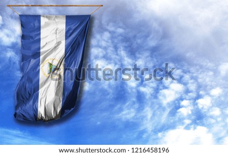Flag of Nicaragua. Vertical flag, against blue sky with place for your text