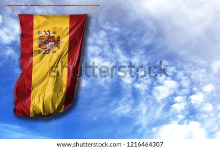 Flag of Spain. Vertical flag, against blue sky with place for your text