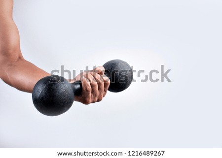 Hand holding dumbbells on white background