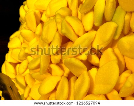 The picture shows yellow candies from the candy store.