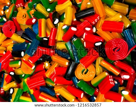 The picture shows red, blue, green, yellow and white candies of different shapes from the candy store.