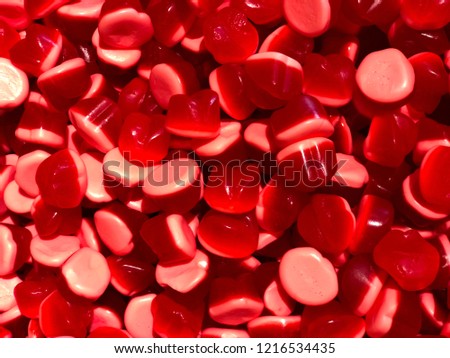 The picture shows red and pink candies  from the candy store.