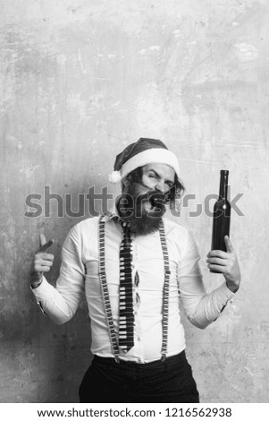 New year guy with in hat. Santa claus man with wine bottle. Party and alcohol drink. Holiday and celebration. Christmas man with happy face.