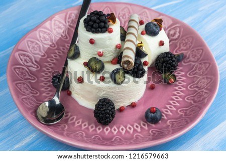 Ice cream with blueberries and blackberries with confectionery.