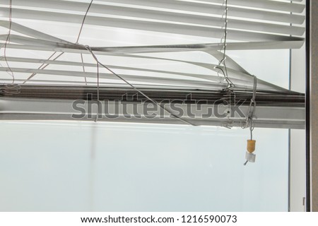 Closeup white Broken curtain, Louvers , shade, blind, shutters, jalousie. Royalty-Free Stock Photo #1216590073