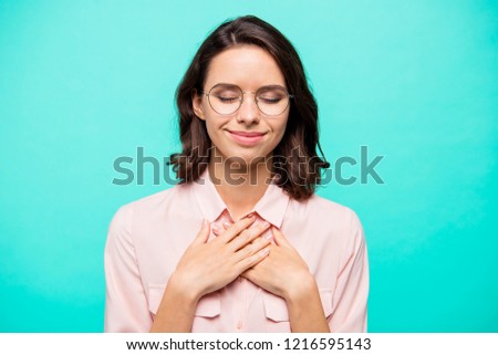 Portrait of nice cute sweet tender attractive charming smart clever intelligent wavy-haired lady in round glasses crossed hands palms closed eyes isolated over turquoise teal pastel background