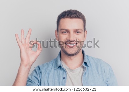 Close up portrait of careless carefree intelligent man show ok sign stand isolated on light gray background make beaming hollywood smile
