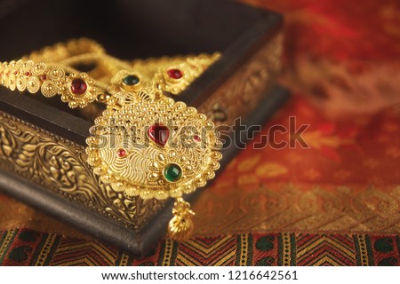 Indian Traditional Gold Necklace with Gemstones Royalty-Free Stock Photo #1216642561