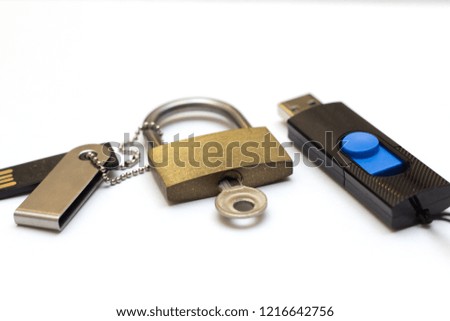 The concept of information storage. Padlock and usb flash drive. locked closed padlock with usb memory stick through it isolated on white background
