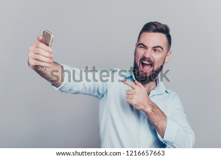 Close up studio photo portrait of attractive nice with bristle stubble brunet toothy beaming grinning guy make take picture on telephone isolated grey background