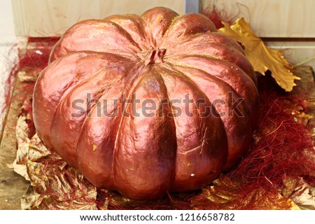 Close-up view of a pumpkin and autumn leaves used for decoration on the Halloween holiday.