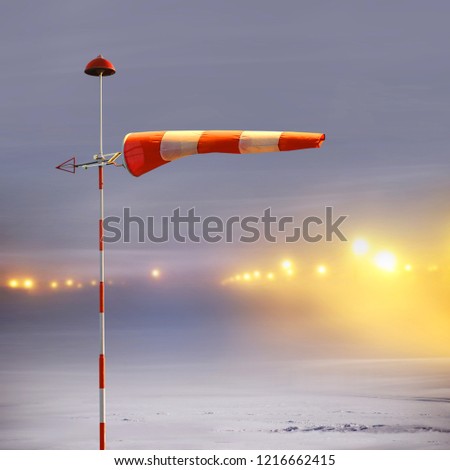 Meteorology windsock inflated by wind in airport at  non-flying night