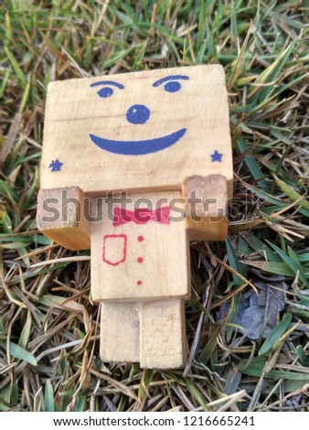 wooden doll. grass, 