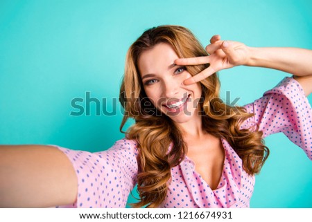Adorable magnificent good-looking lady with her hairdo she show v-sign near eye look at camera make selfie stand isolated on bright turquoise background in pink wear