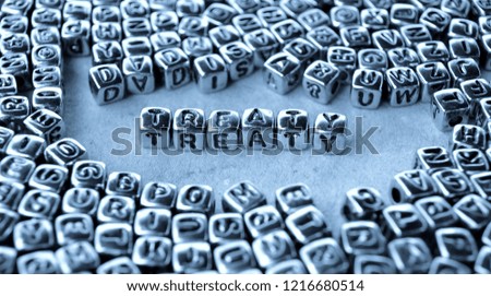 Treaty - Word from Metal Blocks on Paper - Concept Photo on Table
