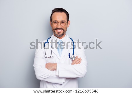 Photo of brunet hair bristle doc assistant folded hands over chest stand isolated on light gray background with hollywood smile Royalty-Free Stock Photo #1216693546