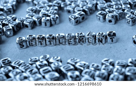 Settlement - Word from Metal Blocks on Paper - Concept Photo on Table
