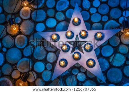 The ornament of wood. Star made of wood. Star with lamps.