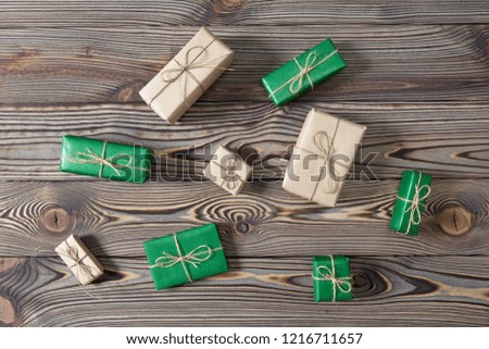 Christmas green and brown gift boxes on wooden background. Flat lay, top view