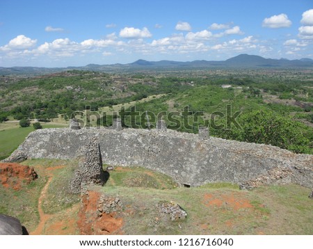 A section of the walls at the UNESCO World Heritage Site of Great Zimbabwe, an ancient city near Masvingo, Zimbabwe, and the capital of the Kingdom of Zimbabwe during the Late Iron Age. Royalty-Free Stock Photo #1216716040