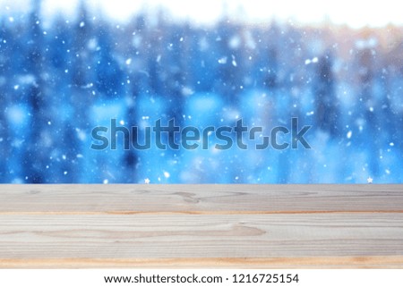 empty wooden table on the winter forest background