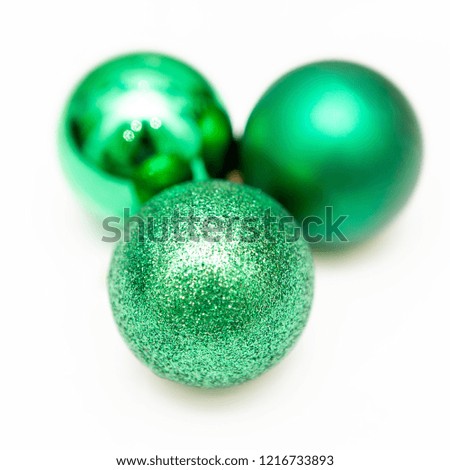 Three green christmas toys, decoration. Glitter. Isolated on white background