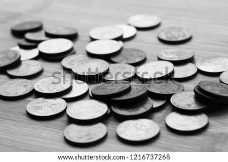 A picture of South African 5 cent coins on a wooden table. This image can be used to represent money or spare change. 